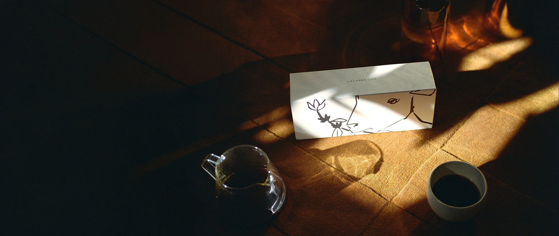 Subscription box next to coffee cup